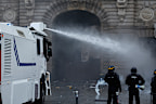 Protests in Paris began peacefully, but became more tense as the day wore on, with police using water cannons and tear gas.