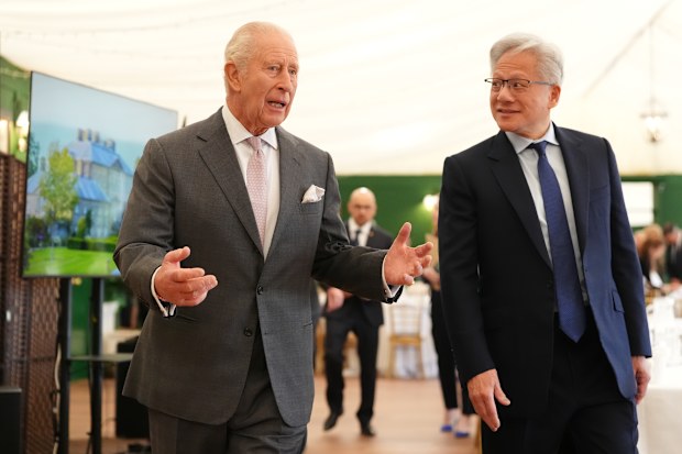 Nvidia chief executive Jensen Huang (R) looks on as King Charles III gives a speech during a meeting for leaders from the artificial intelligence (AI) sector, Government