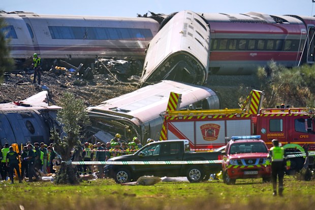 Emergency services work at the scene of a collision between two trains in Urda, Spain