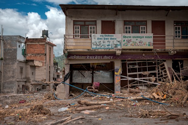 Shops are covered in thick mud and debris following flash floods on August 28, 2026 in Devighat, Nepal. 