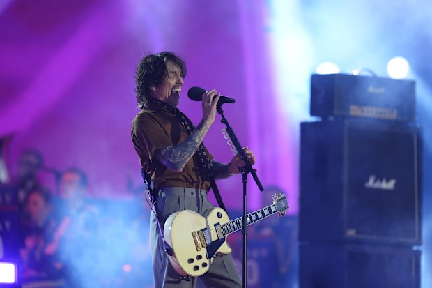Justin Hawkins of The Darkness performs in 2025, ten years after the band reunited.