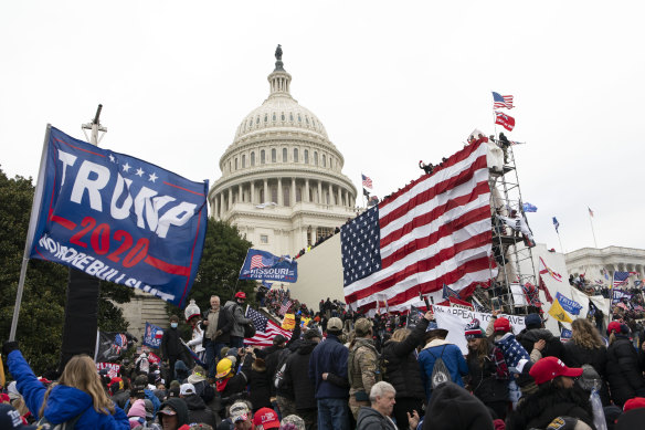 Rioters stand outside the US Capitol in Washington on January 6, 2021.