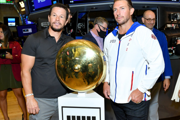 F45 founder Adam Gilchrist, right, and major shareholder Mark Wahlberg on the floor of the New York Stock Exchange for the company’s IPO in July 2021.