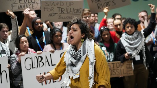 Activists participate in a demonstration for climate finance at the COP29 UN Climate Summit.