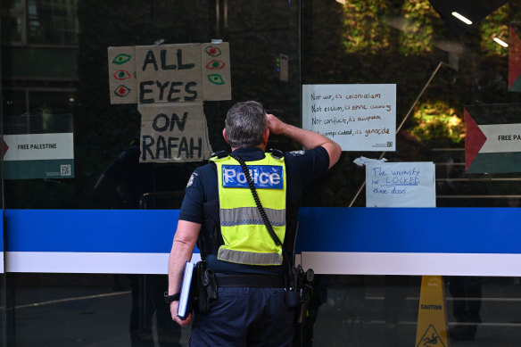 Police assess the situation at Melbourne University.