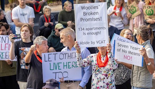 An anti-Woolworths development demonstrator confronts a YIMBY heckler at a community rally in Elsternwick.