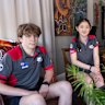 Barker College students Oliver Porter and Jiaqi Wan with robotics teacher Jeser Mross Becker safely back at the school.