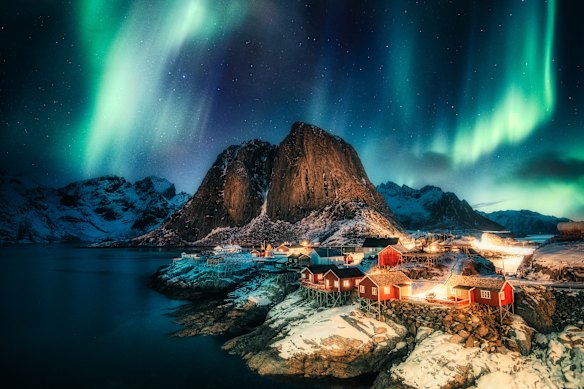 Aurora borealis above the coastline at Hamnoy, Lofoten islands, Norway.