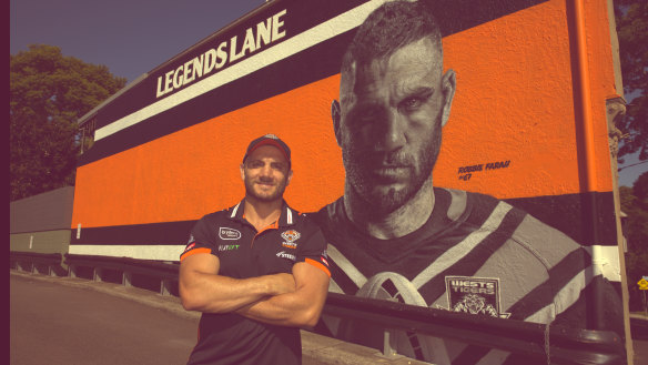 Robbie Farah and the mural dedicated to him at the Sackville Hotel in Rozelle.