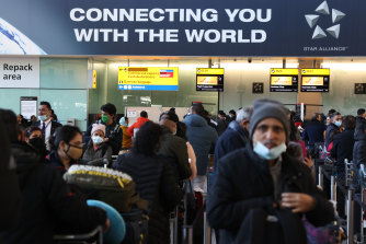 Travellers line up at Heathrow Terminal 2 in London, England. 