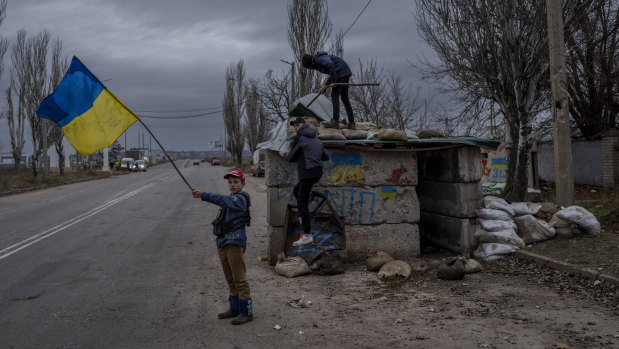 Ukrainian children play at an abandoned checkpoint in Kherson, southern Ukraine.