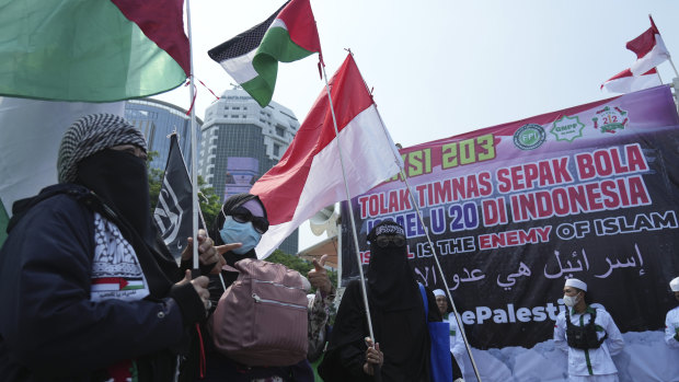 Protesters wave Palestinian flags as they marched in Jakarta last week against Israel’s participation in the Under-20 FIFA World Cup.