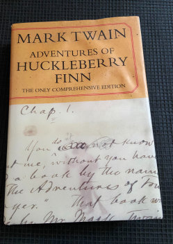 Mark Twain's "Adventures of Huckleberry Finn", which is based on the author's original handwritten manuscript. 