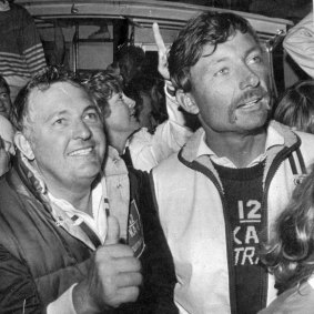 Alan Bond, head of the Australia II syndicate gives the thumbs up as he and skipper, John Bertrand are surrounded by fans following their victory over the America's Cup defender Liberty, 26 September 1983.