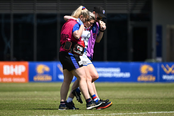 Kirsten McLeod leaves the field injured.