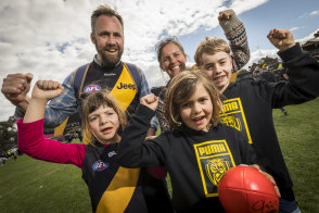 Clockwise from top left: Brett, Lucy, Jacob, Sunday and Olive Cammell soak up the sunshine of a Tigers premiership.