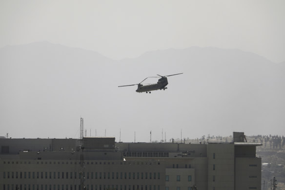 A US Chinook helicopter flies over the US Embassy in Kabulon Sunday as the evacuation mission begins.