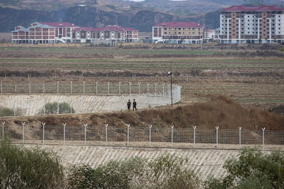 North Korean soldiers patrol the border of a model village near a section of the Great Wall of China, about 20 kilometres from Dandong.