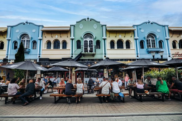 Pastel Spanish Mission-style shopfronts house boutiques, bars and restaurants in the heritage New Regent Quarter.