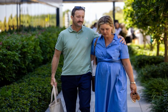 Danny and Elouise Massa, holding a pair of son Joe’s shoes, leave a press conference at the hospital in January.