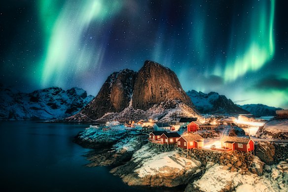 Aurora borealis above the coastline at Hamnoy, Lofoten islands, Norway.
