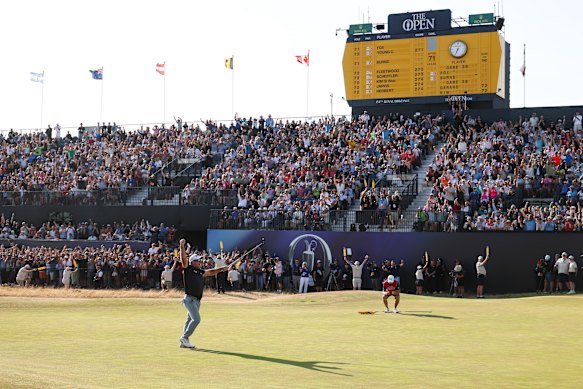 The crowd celebrates the popular player as he makes a birdie putt on the 18th green to secure victory on day four of the British Open. 