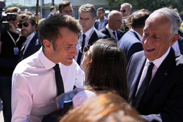 French President Emmanuel Macron kisses a well-wisher at the oceans summit.