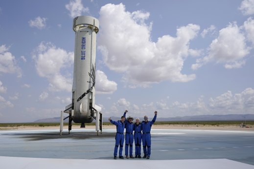 Jeff Bezos, second from left, in front of the rocket that landed safely after their launch from the spaceport near Van Horn, Texas, in July 20. 