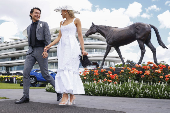 Tim Kano with VRC ambassador Crystal Kimber in the Birdcage at Flemington Racecourse looking for wild card entires for the Fashions on Your Front Lawn competition.
