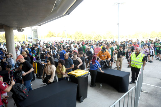 Fans queue to go through security at AAMI Park on Monday night.