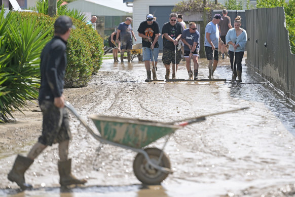 Residents in Taradale, near Napier on Hawke’s Bay, begin cleaning up.