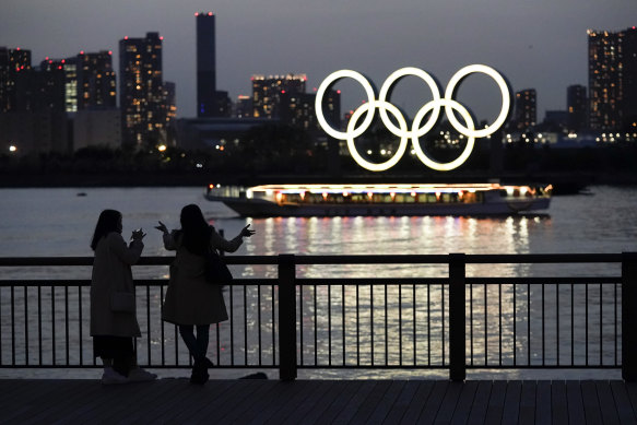 Illuminated Olympic rings float in the waters off Odaiba island in Tokyo.