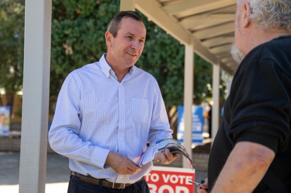 WA Premier Mark McGowan hands out how to vote cards on Saturday. 