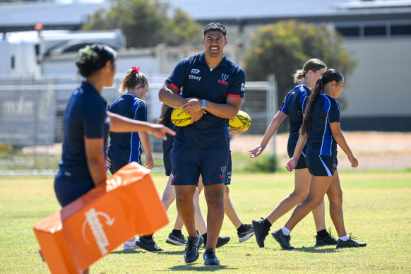 Rebels player Leafi Talataina with the Lara Secondary College students enrolled in the Academy Movement program.