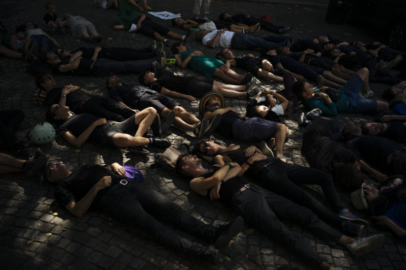 An Extinction Rebellion "die-in" in Paris called on Brazil's President Jair Bolsonaro to act to protect the Amazon rainforest.
