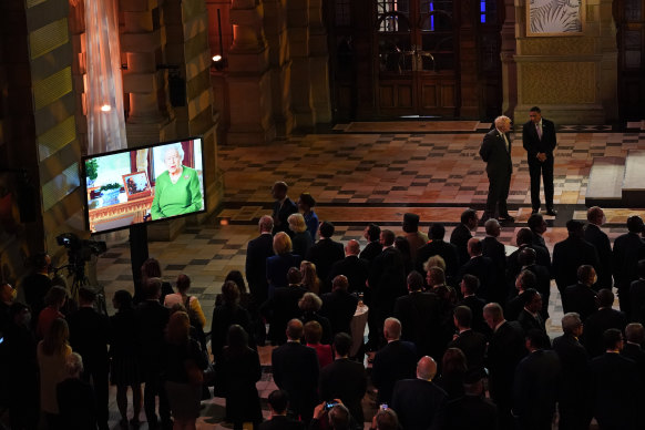 The Queen, on screen, delivers her video message to attendees of an evening reception to mark the opening day of the COP26 summit.