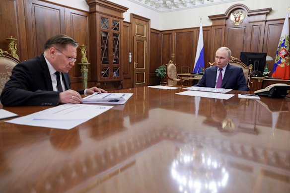 Russian President Vladimir Putin, right, listens to Alexei Likhachev during a meeting in October last year.