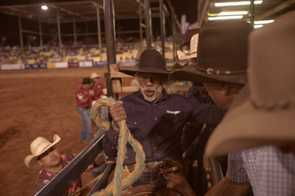 Tommy Gertz, 58, gets ready to ride a big bronc.