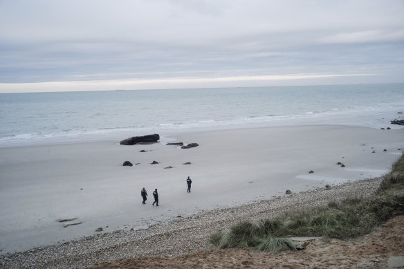 French police officers patrol  a beach in the search for migrants in northern France last week. More than 30 people died when a boat capsized on Wednesday.