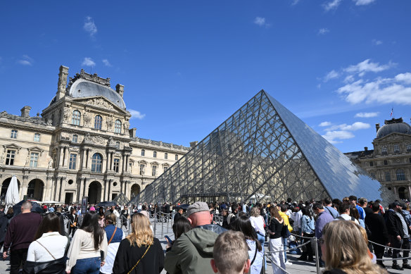 Tourists queue to enter the Louvre. The entry fee will be increased by 30 per cent.