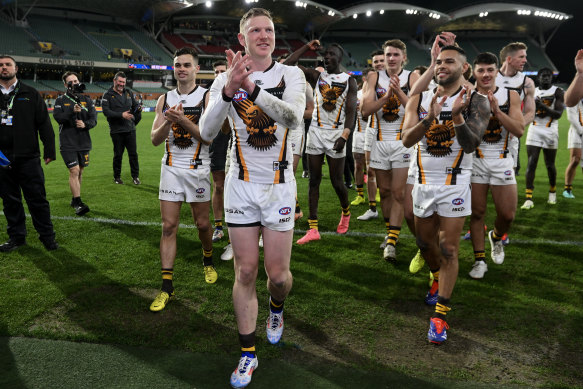 James Sicily of the Hawks
leads his team off for his 150th match after a win against the Crows.