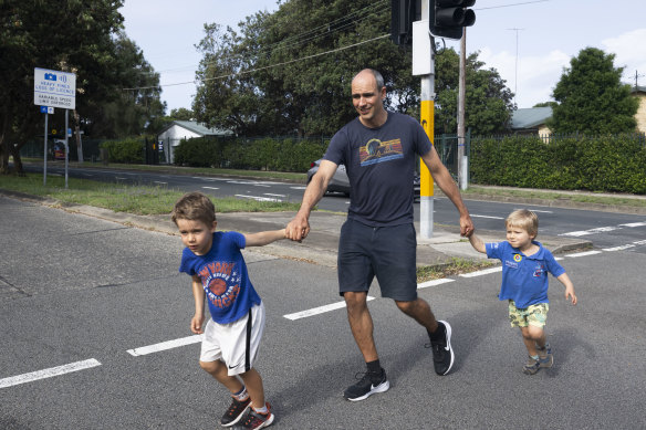 Tym Pieglowski with his sons, Zachary, 6, and Kai, 3, is trying to get the pedestrian walk times increased at traffic lights like this one near his home in Maroubra.