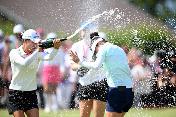 Grace Kim is sprayed with champagne by fellow Australian Minjee Lee.