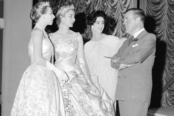 Norman Hartnell visiting David Jones in 1958 with models Maureen Duval (centre), Maggi Eckardt (right) and Diane Masters (left) on 20 October 1958.