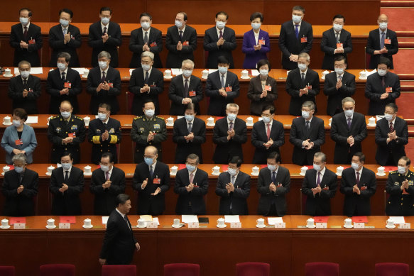 Delegates applaud as Chinese President Xi Jinping arrives at the National People’s Congress 