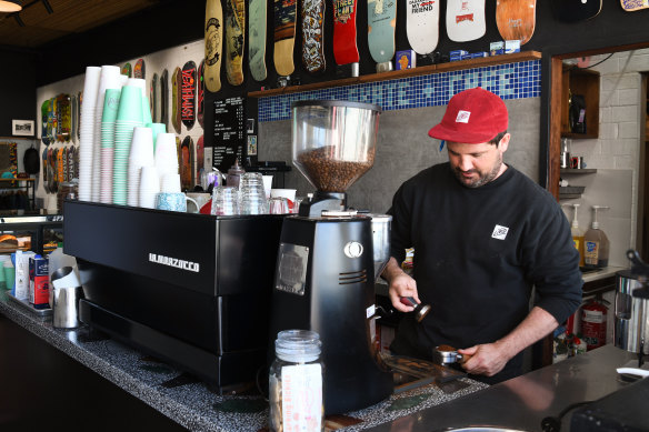 Oliver Tallis makes a customer a coffee at his Livid Skate Cafe in Perth. 