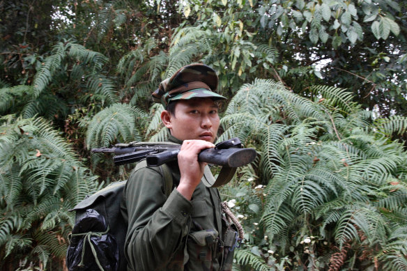 A Kachin Independence Army fighter walks along a jungle path in northern Kachin state, Myanmar.