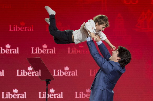 Prime Minister Justin Trudeau lifts his son Hadrien into the air following his speech in Halifax in 2018. 