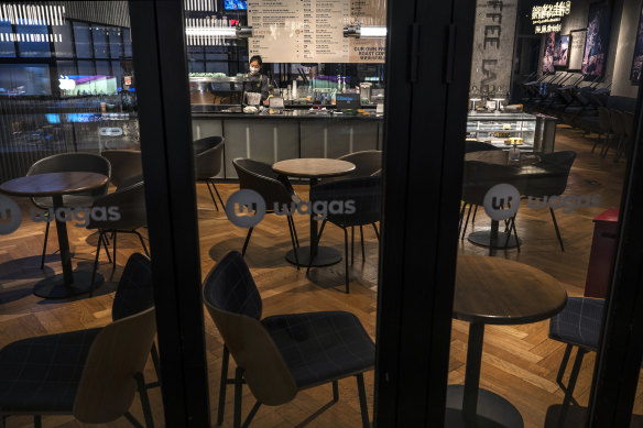 A server wears a mask in an empty restaurant after authorities asked restaurants in the area to only serve takeaway food in an effort to prevent the spread of COVID-19 in Chaoyang District, Beijing, on November 18.