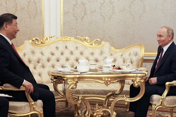 Putin and Chinese President Xi Jinping drink tea during their meeting at the Kremlin ahead of Victory Day celebrations.